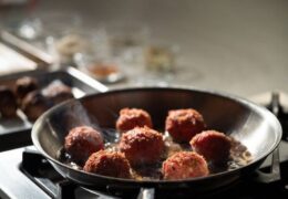 Meatballs being cooked in a pan